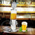 Bar Butler Liquor Pump showcasing a mini beer dispenser next to a glass of beer on a wooden table.