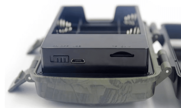 Close-up view of the HD 12MP Night Vision Wildlife Trail Hunting Camera with battery compartment and ports.