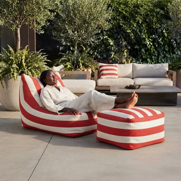 Red and White Striped Outdoor Bean Bag Lounger with matching ottoman in a stylish outdoor setting.