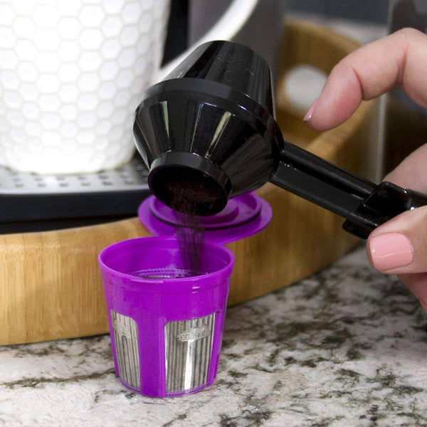 User pouring coffee grounds into a purple cup with the 2 in 1 Coffee Scoop and Funnel for easy coffee prep.