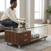 Woman enjoying a cup of coffee at the Glass Top Coffee Table with Drawers in a modern living room.