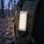 Portable Solar COB Work Light - Bright & Reliable Lighting attached to a backpack in a forest setting.