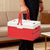 Person holding a Foldable Plastic Camping Storage Box with red and white design, perfect for organizing and storage.