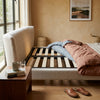 Modern Hotel Upholstered Platform Bed Frame with stylish bedding and a wooden slatted base in a contemporary bedroom setting.