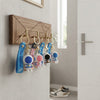 4 3D Silicone Astronaut Keychains hanging on a wooden key holder with a modern design.
