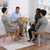 Round Glass 5 Piece Dining Set with Fabric Chairs featuring four people around the table enjoying refreshments and conversation.