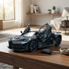 Black Racer Remote Control Toy Car with functional doors and remote on a table in a bright room.