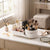 360-Degree Rotating Makeup & Skincare Organizer with makeup products and brushes on a table.