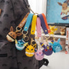 Color Monster Creature Sphere Keychain with Wrist Strap featuring colorful character charms on a backpack.