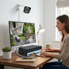 Woman monitoring 4-channel surveillance on a monitor with a 3MP 4-Channel NVR PoE Security Camera Kit.