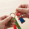 3D Plumber Silicone Keychain held by hands with keys, showcasing a playful plumber design.