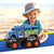 Big Police Monster Truck Toy next to a joyful child on the beach, showcasing its vibrant design and chunky wheels.