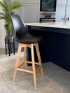 Fusion Living Aqua Soho Plastic Bar Stool in a modern kitchen setting with sleek design and wood legs.