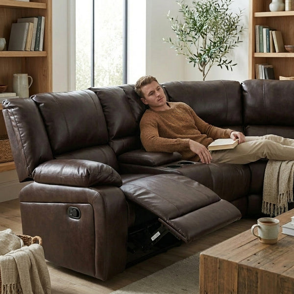 Man relaxing on a Wembley Luxury Recliner Sectional Couch while reading a book.