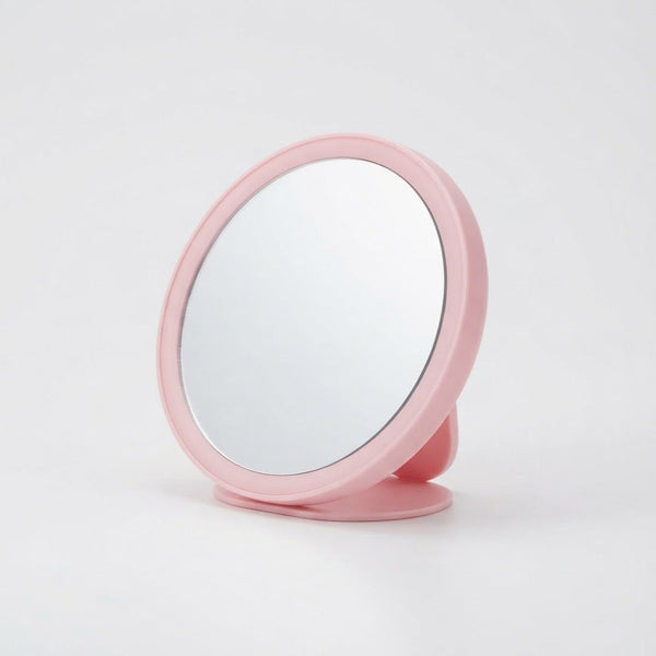 Round Portable Makeup Mirror in pink, offering a convenient reflective surface for makeup and grooming tasks.