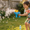 Child enjoying outdoor play with Handheld Bubble Blaster Set, creating a stream of bubbles in a sunny garden.