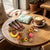Colorful Silicone Capybara Keychain collection on a wooden table with a coffee cup, adding playful charm to accessories.