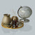 American Round Loop Mirror Tray Gold - Large with decorative items and globe.