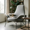 Zen Lounge Chair with cozy blanket and coffee cup in a serene living space.