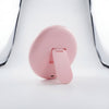 Back view of the Round Portable Makeup Mirror showcasing its pink color and integrated stand design.