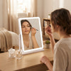Woman applying makeup using Rectangular LED Desktop Makeup Mirror with Touch Control in bright room.