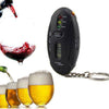 Breathalyzer Alcohol Breath Tester next to beer glasses and wine glass measuring blood alcohol concentration.