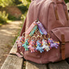 3D Unicorn Silicone Keychain collection hanging from a pink backpack, showcasing colorful unicorn designs.