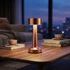 Modern Cordless Copper Turret Table Lamp illuminating a cozy living room setting.