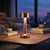 Modern Cordless Copper Turret Table Lamp illuminating a cozy living room setting.