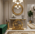 Modern Gold Circular Accent Console Table displayed in an elegant hallway with decorative elements.