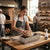Baker using Square Nonstick Aluminum Bread Loaf Pan with freshly shaped dough in a rustic bakery setting.