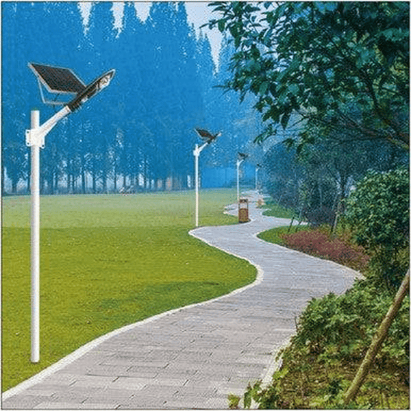 50W Solar Motion Street Light illuminating a garden pathway with solar panels and greenery in the background.
