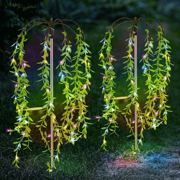 4-Piece Garden Solar Lights illuminating a garden with vibrant greenery and colorful accents at night.