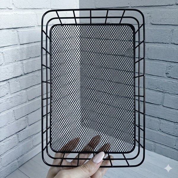 Metal Wire Grid Basket Organizer held against a white brick backdrop, showcasing its sturdy design and mesh texture.