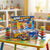 12-Piece Colorful Stackable Spinning Top Set displayed on a colorful table, featuring vibrant spinning tops and a game box.