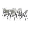 Summit Foldable Table with six folding chairs arranged around it, ideal for events and gatherings.