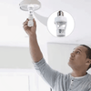 Person installing an E27 Motion Sensor Light Socket in a ceiling fixture.