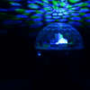 Wireless RGB Party Speaker emitting vibrant blue and green lights, creating an energetic atmosphere for parties.