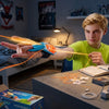 A child playing with a Glow-in-the-Dark String Launcher Toy while shooting out string in a room setting.