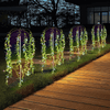 4-Piece Garden Solar Lights illuminating a garden pathway at night with hanging plants.