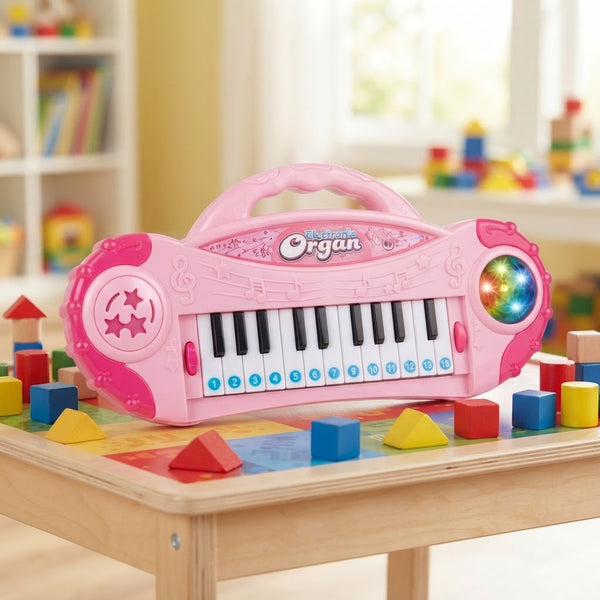 A pink Electronic Organ Keyboard for kids on a play table surrounded by colorful building blocks.