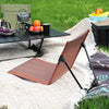 Ultra-Lightweight Folding Portable Camping Chair set up at a picnic with food and drinks on a grassy area.