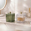 Clear Ribbed Acrylic Storage Box with Dust-Proof Lid displayed alongside a green decorative container on a marble surface.