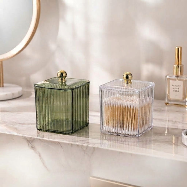 Clear Ribbed Acrylic Storage Box with Dust-Proof Lid displayed alongside a green decorative container on a marble surface.