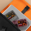 Portable Pill Organiser on a laptop with vibrant orange background and black bag, neatly sorted medications visible.