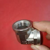 304 Stainless Steel 90 Degree Elbow Pipe Fitting with threaded connection held in hand.