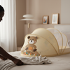 Baby Nest Lounger Travel Crib with Mosquito Net featuring a cute bear design on a bed.