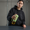 Clear Glass Spray Atomization Oil Bottle in hand, featuring a green spray top, ideal for controlled oil application.