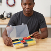 Boxed Flame Retardant Heat Shrink Tubing set displayed by a man, showcasing organized electrical insulation materials.