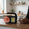 Rechargeable Camping Light with Solar Charger and Fan on a kitchen counter with a person holding a cup.